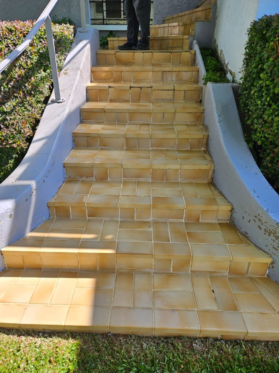 Après : le même escalier, carrelage jaune et orangé.